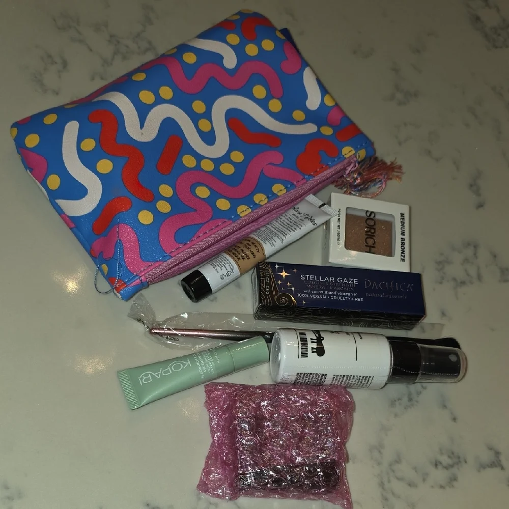Colorful Patterned Makeup Bag with Assorted Beauty Products